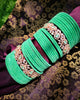 B02004_Elegant flowery design Bangles studded with American Diamond stones with a touch of mint green stones with delicate stone work. Also 2 Dozens of mint green velvet bangles