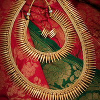 N03079_Grand Choker classic matte gold polished temple jewelry style crafted design gold plated necklace set embellished with ruby and green stones .